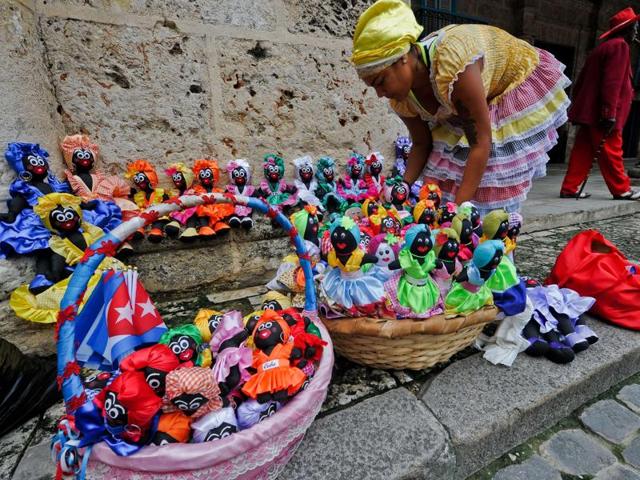 A Cuban vendor displays dolls for sale at a street of the Old Havana on December 16, 2015. (AFP)