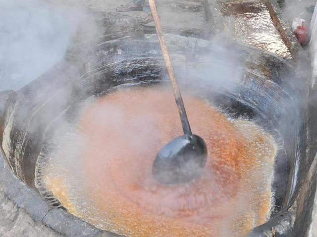 The sugarcane juice is then heated for about one hour till it is reduced to nearly one- third of the original volume. The dried wood pulp from the crushed sugar cane is used as a fuel for the furnace. (Pardeep Pandit/HT Photo)