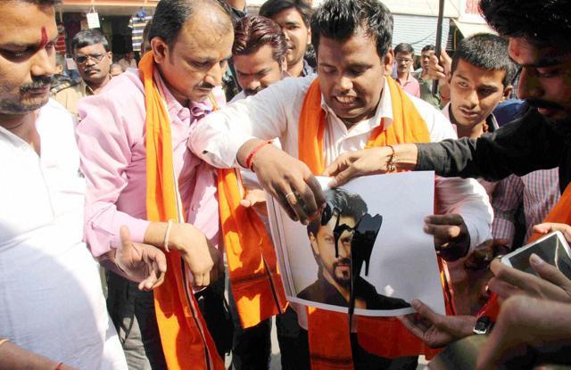 Hindu Rashtriya Sena activists blacken a poster of actor Shah Rukh Khan during a protest against the screening of Dilwale near a mall in Mumbai on Friday. (PTI) Hindu Rashtriya Sena activists blacken a poster of actor Shah Rukh Khan during a protest against the screening of Dilwale near a mall in Mumbai on Friday. (PTI)