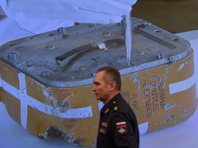 A Russian military official passes by a screen showing a live broadcast of the opening of the flight recorder from the Russian Sukhoi Su-24 bomber which was shot down by a Turkish jet. (AFP) A Russian military official passes by a screen showing a live broadcast of the opening of the flight recorder from the Russian Sukhoi Su-24 bomber which was shot down by a Turkish jet. (AFP)