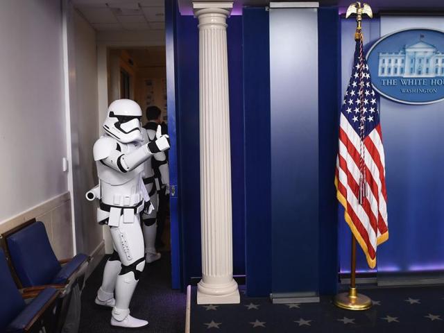 A Storm Trooper gives the thumbs up as he leaves the briefing room at the White House after making an appearance with the Press Secretary. The new Star Wars movie The Force Awakens was shown at the White House for children of military families. (AFP)