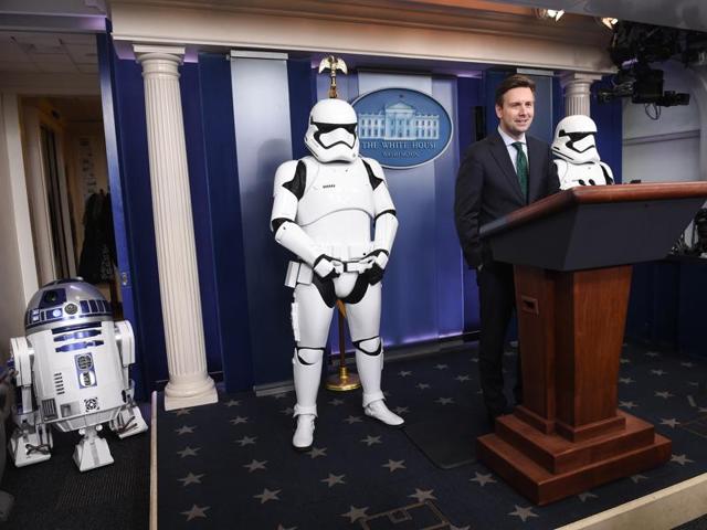 US Press Secretary Josh Earnest speaks to the press in the briefing room at the White House with Star Wars characters R2D2 and Storm Troopers. The new Star Wars movie The Force Awakens was shown at the White House for children of military families. (AFP)