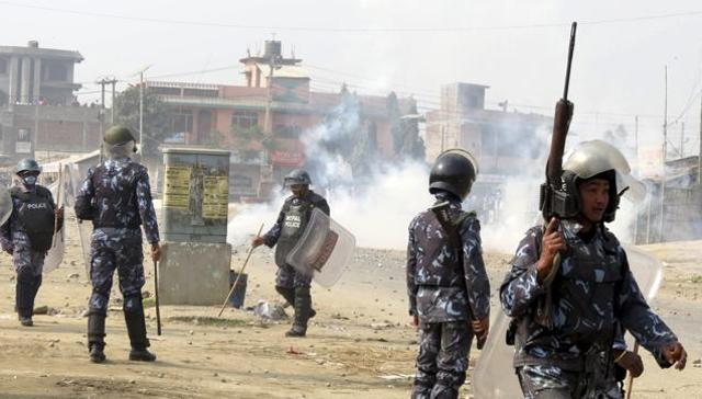 Nepalese policemen use tear gas to disperse ethnic Madhesi protesters in Gaur, a town about 160 km south of Kathmandu on Dec.20, 2015. Police opened fire on protesters who were attempting to attack a police station in southern Nepal on Sunday, killing one, officials said. (AP) Nepalese policemen use tear gas to disperse ethnic Madhesi protesters in Gaur, a town about 160 km south of Kathmandu on Dec.20, 2015. Police opened fire on protesters who were attempting to attack a police station in southern Nepal on Sunday, killing one, officials said. (AP)