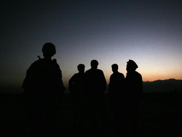 In this file photo, U.S. Army soldiers stand with Afghan policemen before a joint patrol of Qalanderkhail, outside of Bagram Air Field in Afghanistan. An Afghan official says that a suicide bomber has killed three foreign troops in an attack on a joint Afghan-NATO foot patrol on Monday, Dec. 21, 2015. Mohammad Asim Asim, governor of Parwan province said an attacker on a motorcycle rammed a group of eight troops as they patrolled a village near Bagram Airfield, 45 kilometers (28 miles) north of Kabul. (AP) In this file photo, U.S. Army soldiers stand with Afghan policemen before a joint patrol of Qalanderkhail, outside of Bagram Air Field in Afghanistan. An Afghan official says that a suicide bomber has killed three foreign troops in an attack on a joint Afghan-NATO foot patrol on Monday, Dec. 21, 2015. Mohammad Asim Asim, governor of Parwan province said an attacker on a motorcycle rammed a group of eight troops as they patrolled a village near Bagram Airfield, 45 kilometers (28 miles) north of Kabul. (AP)