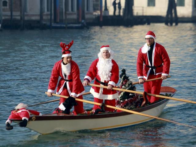 People dressed as Santa Claus row a boat on Venice's Grand Canal, in northern Italy. (REUTERS) People dressed as Santa Claus row a boat on Venice's Grand Canal, in northern Italy. (REUTERS)