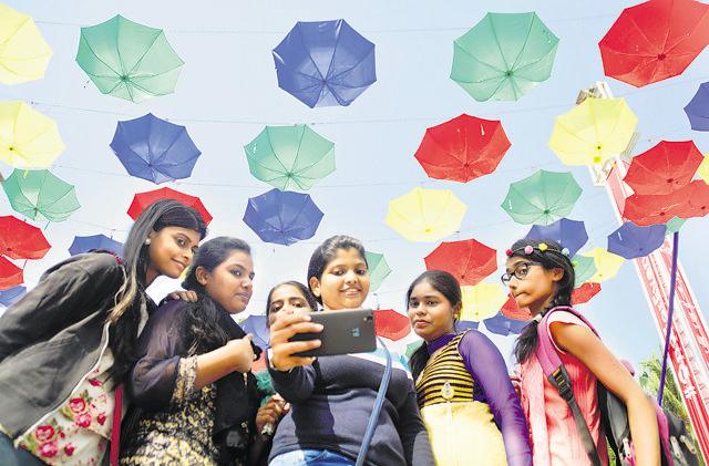 Mumbai, India - 19 December 2015: Students taking selfie in front of art installed at Mood Indigo which is annual fest of IIT Bombay Powai in Mumbai, India, on Saturday, December 19, 2015.(Prashant Waydande)