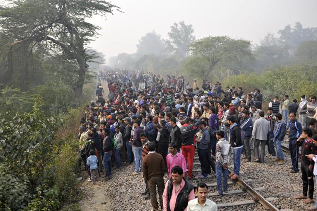 Residents gather near the crash site. Sources told HT the pilot noticed the technical issue minutes after taking off at 9.37 am but avoided the Delhi-Ahmadabad Ashram Express that was passing through a nearby railway crossing and other residential areas to avoid more casualties. (Vipin Kumar/HT Photo) Residents gather near the crash site. Sources told HT the pilot noticed the technical issue minutes after taking off at 9.37 am but avoided the Delhi-Ahmadabad Ashram Express that was passing through a nearby railway crossing and other residential areas to avoid more casualties. (Vipin Kumar/HT Photo)