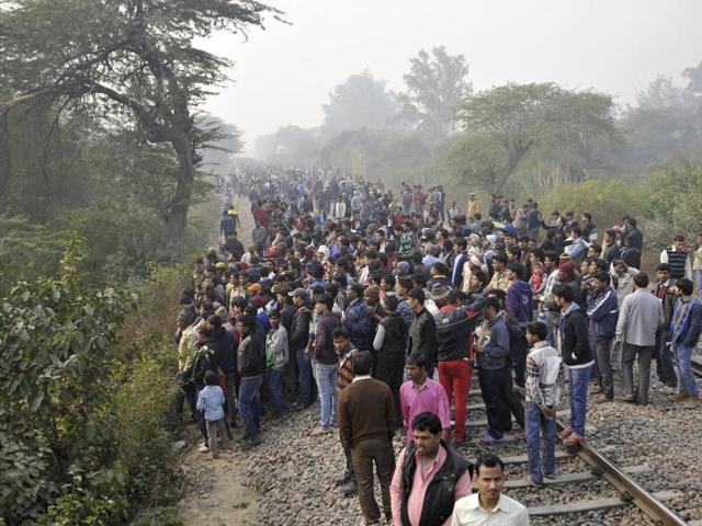 Citizens gather at the site of the crash. According to officials, Ashram Express train was passing by when the plane crashed. (Vipin Kumar/Hindustan Times)