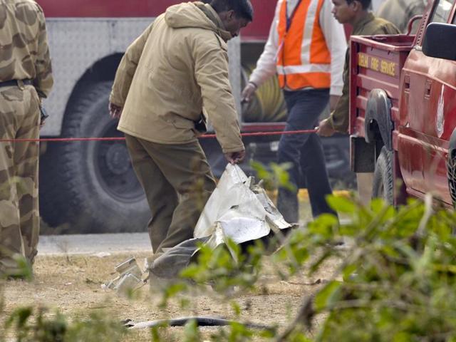 A part of the Ranchi-bound BSF aircraft which narrowly missed an express train and crashed in west Delhi’s Dwarka area after developing a technical snag, killing all ten on board.((Photo by Vipin Kumar/ Hindustan Times))