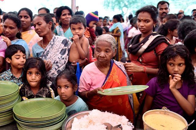 Flood affected people waiting for the food at a relief camp arranged by an NGO in Chennai. (PTI File Photo) Flood affected people waiting for the food at a relief camp arranged by an NGO in Chennai. (PTI File Photo)