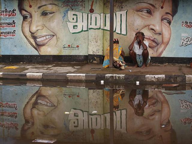 A flood-affected couple sits along a flooded roadside under a picture of J Jayalalithaa , chief minister of Tamil Nadu, in Chennai. The CM has sought a relief package of Rs 25,912 Crore from the Centre. (Reuters File Photo) A flood-affected couple sits along a flooded roadside under a picture of J Jayalalithaa , chief minister of Tamil Nadu, in Chennai. The CM has sought a relief package of Rs 25,912 Crore from the Centre. (Reuters File Photo)