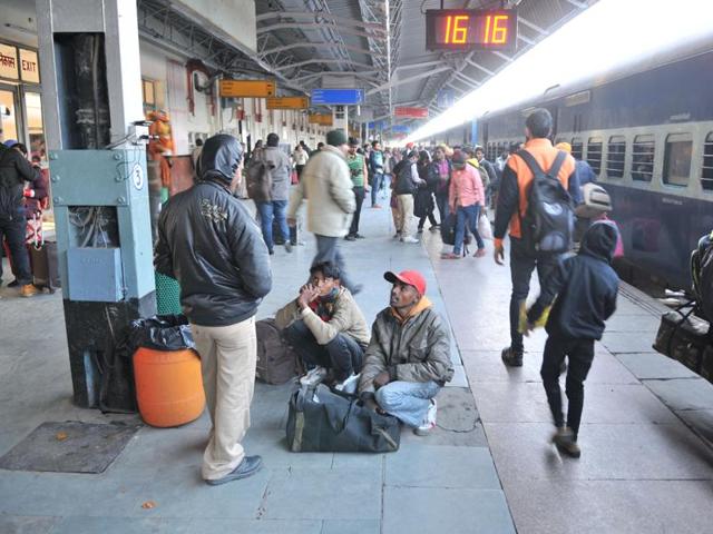 Passengers are forced to sit on the floor or stand in the absence of enough benches on the platform at the Jalandhar railway station on Monday. (Pardeep Pandit/HT) Passengers are forced to sit on the floor or stand in the absence of enough benches on the platform at the Jalandhar railway station on Monday. (Pardeep Pandit/HT)