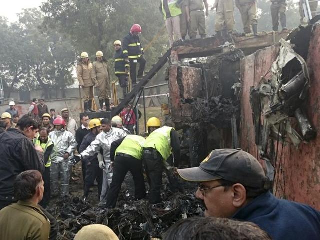 A Ranchi-bound BSF aircraft narrowly missed an express train and crashed in west Delhi’s Dwarka after developing a technical snag, killing all ten passengers on board. (HT Photo)