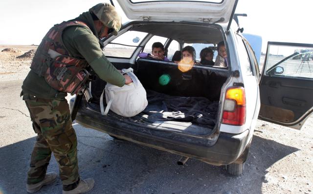 An Afghan National Army soldier searches a civilian car at a checkpoint on the way to the Sangin district of Helmand province, Afghanistan. (AP) An Afghan National Army soldier searches a civilian car at a checkpoint on the way to the Sangin district of Helmand province, Afghanistan. (AP)