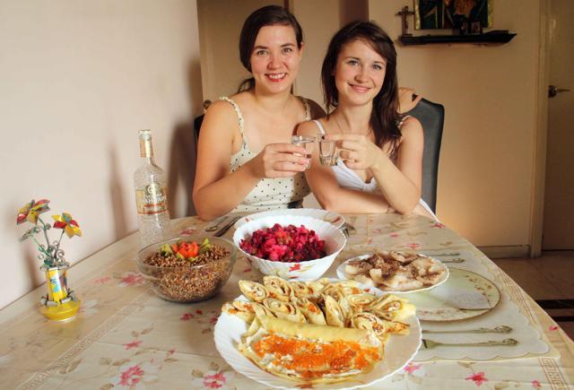 Russians expats Natalia Durbanova (left) and Olga Shabalina celebrate Christmas on January 7 with a festive staples including buckwheat garnish, a vinegret salad of pickled beets, and fried fish served alongside shots of homemade vodka. (Pramod Thakur/HT photo)