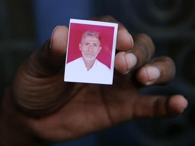 A relative holds a photograph of slain Indian villager Mohammad Akhlaq at his home in the village of Bisada, some 35 kilometres (22 miles) north-east of New Delhi.(AFP Photo)