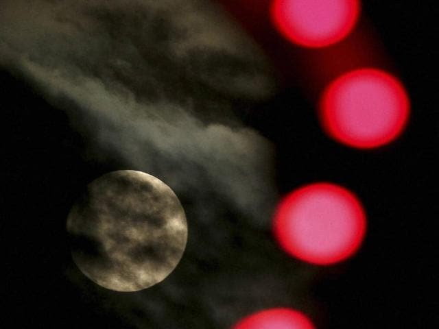 The nearly full-moon is seen among Christmas lights at a holiday display in Lenexa, Kan.(AP) The nearly full-moon is seen among Christmas lights at a holiday display in Lenexa, Kan.(AP)