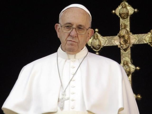 Pope Francis waves from the balcony of St Peter's basilica during the traditional "Urbi et Orbi" Christmas message to the city and the world.(AFP Photo)
