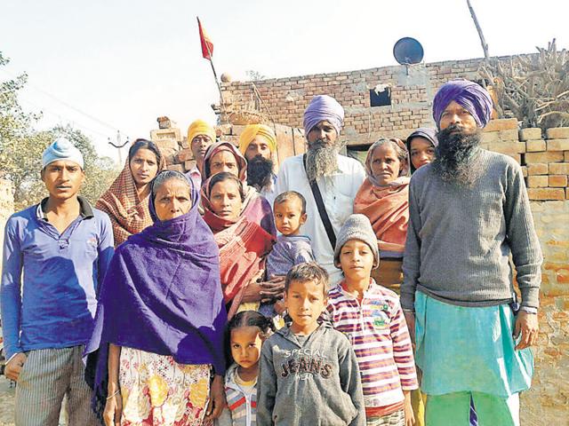 Sukhdev Singh with his family who were boycotted by the upper caste landlords at Burj Dhilwan village in Mansa district on Friday.(HT Photo)