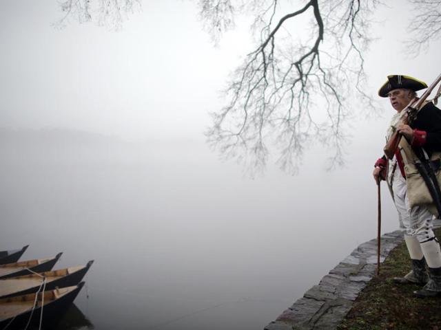 Revolutionary War re-enactor Bill Strunk looks at the fog covering the river before the re-enactment of Washington crossing the Delaware River. (AP) Revolutionary War re-enactor Bill Strunk looks at the fog covering the river before the re-enactment of Washington crossing the Delaware River. (AP)