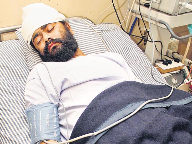 Jagmohan undergoing treatment at a private hospital in Jalandhar. He had suffered serious injuries in left ear and hand. (HT Photo) Jagmohan undergoing treatment at a private hospital in Jalandhar. He had suffered serious injuries in left ear and hand. (HT Photo)