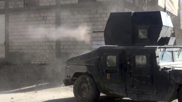 The advance by the government forces has also been hampered by the possible presence of dozens of families trapped in the combat zone and used by IS as human shields. (AP Photo)