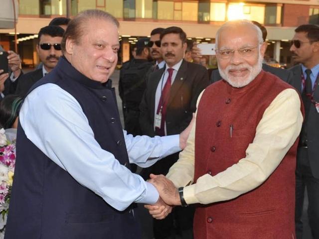 In this photo released by Press Information Department, India's Prime Minister Narendra Modi, right, shakes hands with his Pakistani counterpart Nawaz Sharif in Lahore, Pakistan, Friday.(AP)