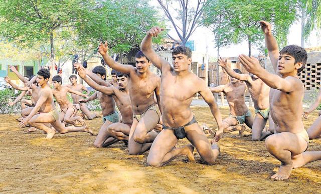 Wrestlers train at the Shaheed Bhagat Singh International wrestling academy, Mirchpur in Hisar district. (HT Photo)