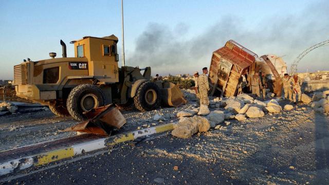 A bulldozer removes fortifications set by the Islamic State group as Iraqi Security forces advance their position in downtown Ramadi, 70 miles (115 kilometers) west of Baghdad, Iraq. (AP Photo) A bulldozer removes fortifications set by the Islamic State group as Iraqi Security forces advance their position in downtown Ramadi, 70 miles (115 kilometers) west of Baghdad, Iraq. (AP Photo)