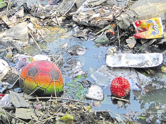 The ball with which the girl was last seen playing floats in the open drain.(Sakib Ali/HT Photo)