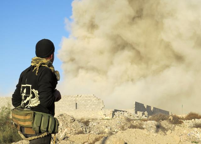 An Iraqi pro-government forces member watches smoke billowing in Ramadi's Hoz neighbourhood, about 110 kilometers west of the capital Baghdad, during military operations. (AFP) An Iraqi pro-government forces member watches smoke billowing in Ramadi's Hoz neighbourhood, about 110 kilometers west of the capital Baghdad, during military operations. (AFP)
