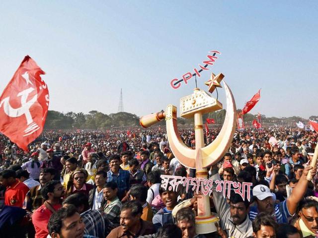 CPI(M) activists hold flags and a huge party symbol at a rally in Kolkata. (PTI) CPI(M) activists hold flags and a huge party symbol at a rally in Kolkata. (PTI)