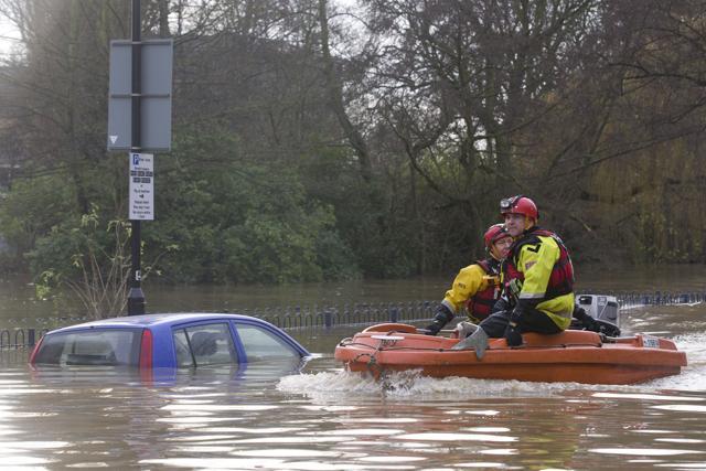 Members of the emergency services search for residents affected by floodwaters in streets close to The River Foss, after it burst it's banks in York. (AFP) Members of the emergency services search for residents affected by floodwaters in streets close to The River Foss, after it burst it's banks in York. (AFP)
