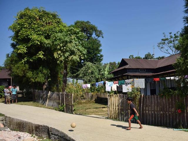 In this photograph taken on November 8, 2015, a child plays football in Mawlynnong, Meghalaya. (AFP)