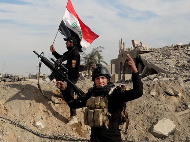 Iraqi security forces raise an Iraqi flag near the provincial council building in central Ramadi. (AP) Iraqi security forces raise an Iraqi flag near the provincial council building in central Ramadi. (AP)