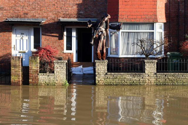 TOPSHOT - A resident dressed as the character Captain Jack Sparrow from Pirates of the Caribbean film series stands outside his flooded house after the adjacent River Foss burst it's banks in York. (AFP) TOPSHOT - A resident dressed as the character Captain Jack Sparrow from Pirates of the Caribbean film series stands outside his flooded house after the adjacent River Foss burst it's banks in York. (AFP)