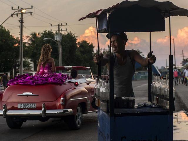 As per myths and legends of Latin America, girls were prepared to be married or become nuns. A soft drink vendor smiles as he watches Amanda Teresa Betancur, who lives in Cuba, ride in a classic American convertible, on her way to her quinceanera party in Havana, Cuba on December 13, 2015. The daughters of workers in Cuba’s emerging private sector are helping fuel business. With the economic reforms, many families on the island now have extra cash to spend for quniceanera celebrations. (AP) As per myths and legends of Latin America, girls were prepared to be married or become nuns. A soft drink vendor smiles as he watches Amanda Teresa Betancur, who lives in Cuba, ride in a classic American convertible, on her way to her quinceanera party in Havana, Cuba on December 13, 2015. The daughters of workers in Cuba’s emerging private sector are helping fuel business. With the economic reforms, many families on the island now have extra cash to spend for quniceanera celebrations. (AP)