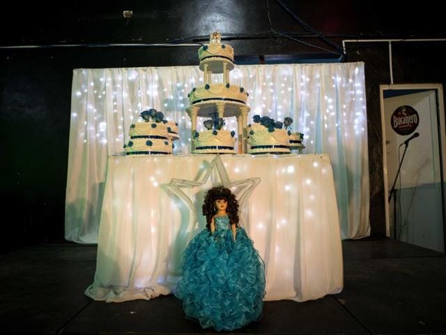 A doll and cake sit ready for the quinceanera party organised to celebrate Daniela Santos Torres’ 15th birthday (features before) in the town of Punta Brava near Havana, Cuba, December 20, 2015. Daniela left Cuba when she was 3, returning in December for her quinceanera photos and party. She now lives in Glendale, Arizona, where her father runs a home remodelling business. She said returning to Cuba for her celebration was “a dream”, allowing her to include her extended family and friends on the island. (AP) A doll and cake sit ready for the quinceanera party organised to celebrate Daniela Santos Torres’ 15th birthday (features before) in the town of Punta Brava near Havana, Cuba, December 20, 2015. Daniela left Cuba when she was 3, returning in December for her quinceanera photos and party. She now lives in Glendale, Arizona, where her father runs a home remodelling business. She said returning to Cuba for her celebration was “a dream”, allowing her to include her extended family and friends on the island. (AP)