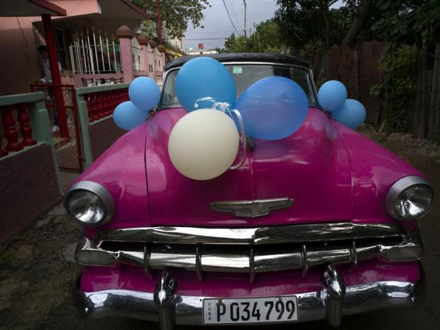 A classic American car sits decorated with balloons before taking Daniela Santos Torres, 15, to her quinceanera party in the town of Punta Brava near Havana, Cuba, December 20, 2015. (AP) A classic American car sits decorated with balloons before taking Daniela Santos Torres, 15, to her quinceanera party in the town of Punta Brava near Havana, Cuba, December 20, 2015. (AP)
