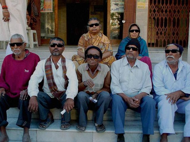 Seven patients sitting outside the Sadhu Vaswani hospital in Rajkot where they lost their vision after retina operation on Monday. (PTI) Seven patients sitting outside the Sadhu Vaswani hospital in Rajkot where they lost their vision after retina operation on Monday. (PTI)