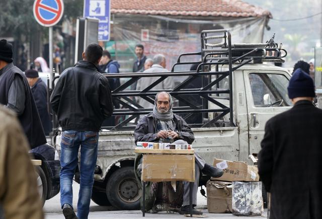 Syrian Abu Ziad sells cigarettes while sitting in front of his decades-old pickup truck in Damascus. (AFP) Syrian Abu Ziad sells cigarettes while sitting in front of his decades-old pickup truck in Damascus. (AFP)