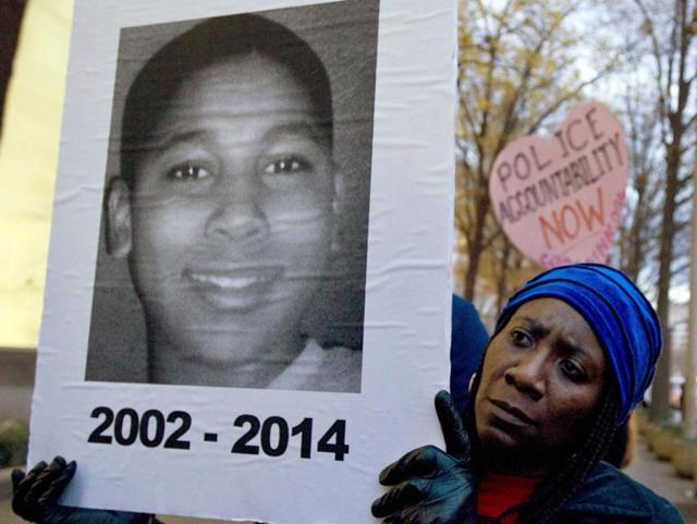 Barricades were set up outside the county courthouse in Cleveland in case of protests, and about two dozen people gathered in the cold rain at the recreation center where Tamir was shot, some holding signs with photos of the boy and others killed by police in the US. (AP) Barricades were set up outside the county courthouse in Cleveland in case of protests, and about two dozen people gathered in the cold rain at the recreation center where Tamir was shot, some holding signs with photos of the boy and others killed by police in the US. (AP)