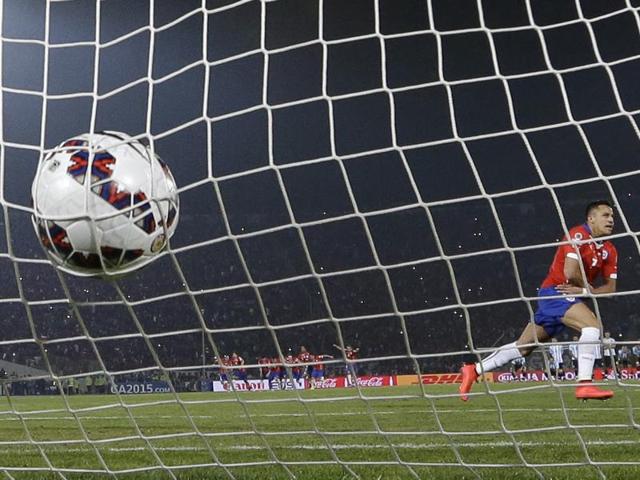 Champions of South America, finally: Chile's Alexis Sanchez calmly slots the ball into the goal for the winning penalty against Argentina before proceeding to take off his shirt in celebration as Chile won their first Copa America. (AP Photo) 