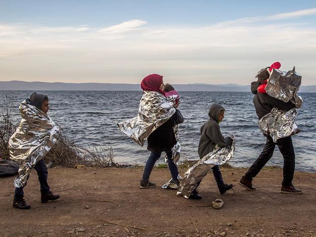 A Syrian family covered with thermal blankets walk as they arrive from Turkey on the Greek island of Lesbos in October. (AP File Photo) A Syrian family covered with thermal blankets walk as they arrive from Turkey on the Greek island of Lesbos in October. (AP File Photo)