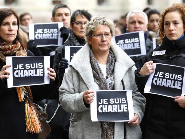 People stand with placards reading "Je Suis Charlie” (I am Charlie) during a minute of silence in Strasbourg for victims of the shooting at the Paris offices of weekly satirical newspaper Charlie Hebdo. (Reuters File Photo) People stand with placards reading "Je Suis Charlie” (I am Charlie) during a minute of silence in Strasbourg for victims of the shooting at the Paris offices of weekly satirical newspaper Charlie Hebdo. (Reuters File Photo)
