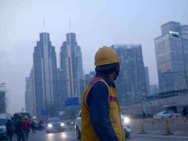 A Chinese worker walks along a street after work in Beijing. Construction workers, machine operators in factories, office cleaners have been denied, and their children have long been denied equal access to public services such as schools, hospitals and housing under a decades-old household registration system known as “hukou”. (AFP) A Chinese worker walks along a street after work in Beijing. Construction workers, machine operators in factories, office cleaners have been denied, and their children have long been denied equal access to public services such as schools, hospitals and housing under a decades-old household registration system known as “hukou”. (AFP)