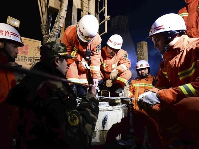 Rescuers try to contact the trapped people at a collapsed mine in Pingyi County, east China's Shandong Province.(Guo Xulei/Xinhua News Agency via AP)