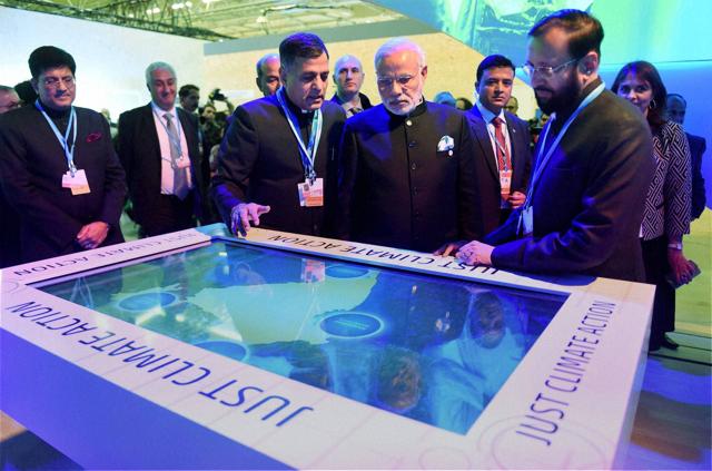 PM Narendra Modi with minister of state for environment, forest and climate change Prakash Javadekar in the India Pavilion at the COP21 Climate Change conference in Le Bourget, outside Paris on Monday. (PTI)