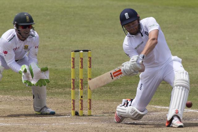 England's Jonny Bairstow plays a shot as South Africa's AB de Villiers looks on during the first cricket test match in Durban. (Reuters Photo)