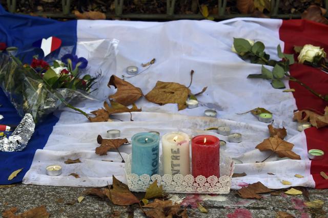 Candles bearing the colours of the French flag burn at a makeshift memorial for the victims of the attacks in front of the Bataclan theatre in Paris, on November 18, 2015. (AFP File Photo) Candles bearing the colours of the French flag burn at a makeshift memorial for the victims of the attacks in front of the Bataclan theatre in Paris, on November 18, 2015. (AFP File Photo)